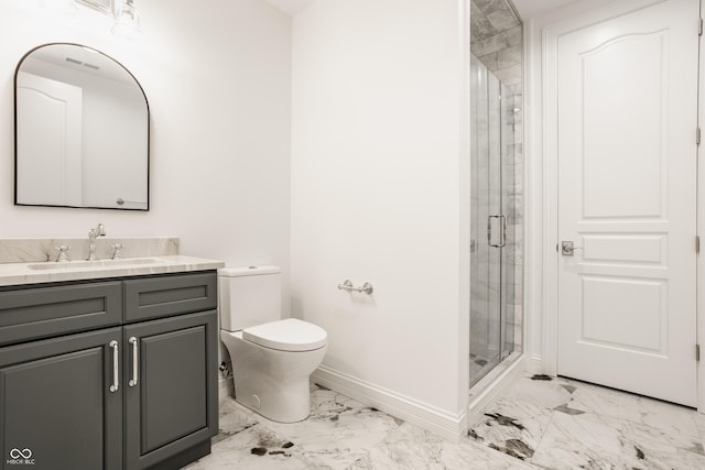 bathroom featuring vanity, toilet, and a shower with shower door