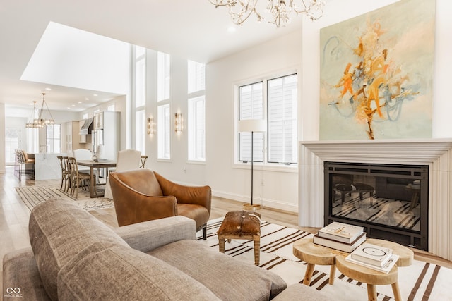 living room with light wood-type flooring and a chandelier