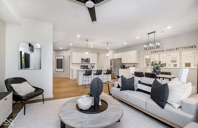 living room featuring a notable chandelier and light hardwood / wood-style floors