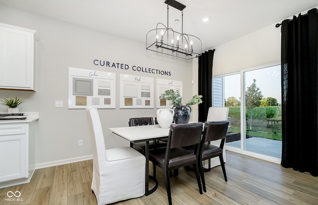 dining area featuring an inviting chandelier and light hardwood / wood-style floors