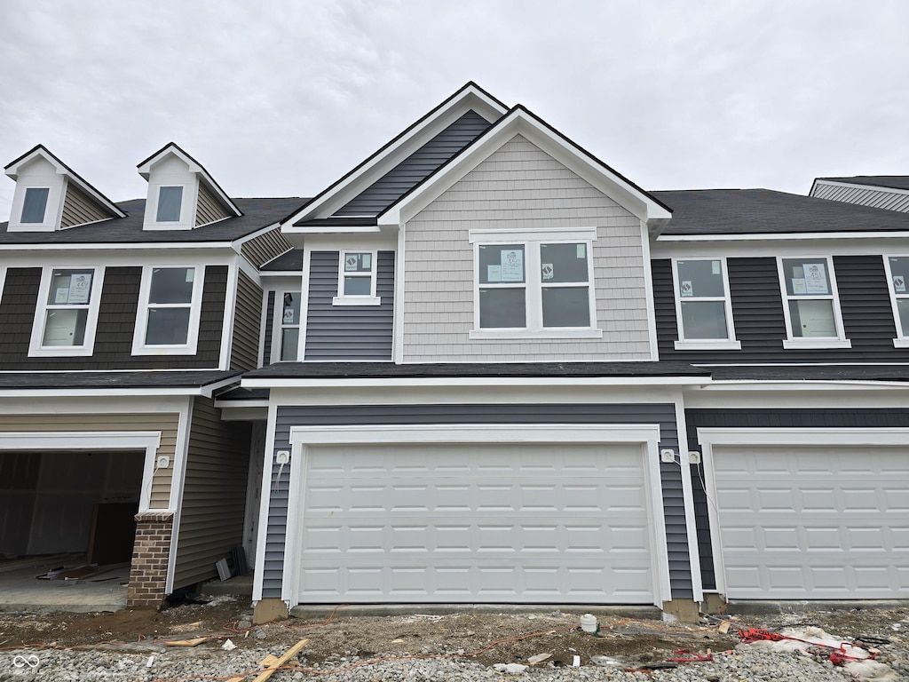 townhome / multi-family property featuring a garage