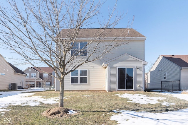 snow covered house featuring central air condition unit