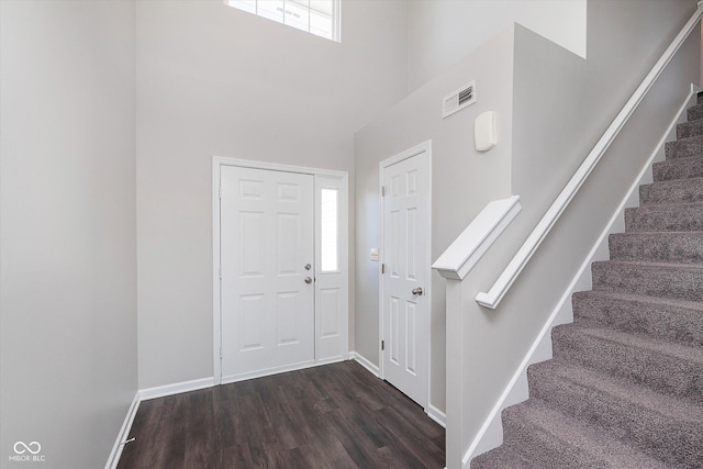 entrance foyer featuring dark wood-type flooring and a high ceiling