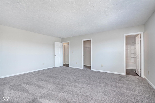 carpeted spare room featuring a textured ceiling