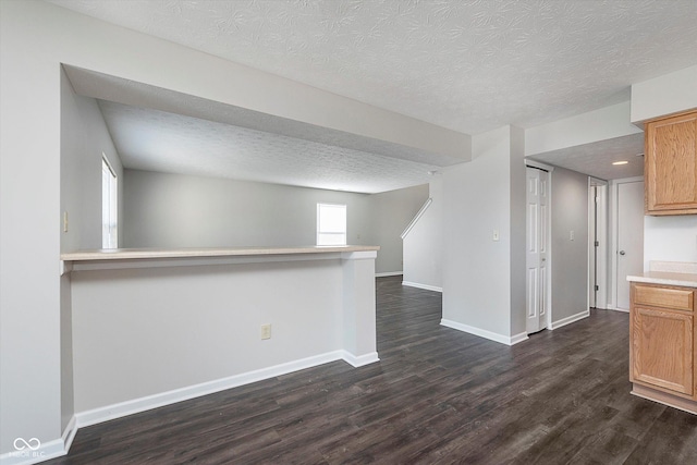 interior space featuring dark wood-type flooring and a textured ceiling