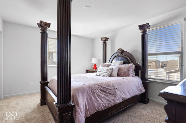 carpeted bedroom featuring multiple windows