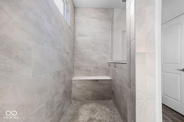 bathroom featuring tiled shower