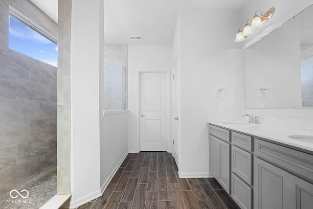 bathroom featuring vanity and a tile shower