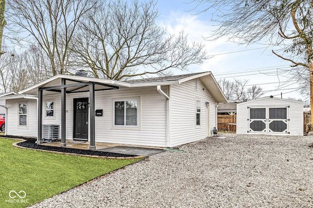 view of front of home with a shed and a front lawn