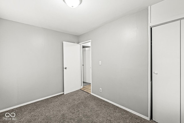 unfurnished bedroom featuring carpet floors and a closet