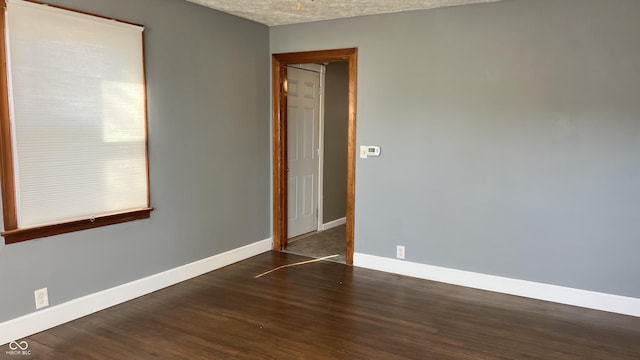 spare room with dark hardwood / wood-style floors