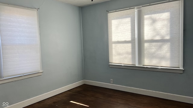 empty room with dark hardwood / wood-style floors