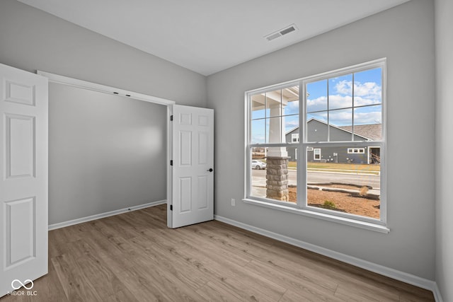 spare room with light hardwood / wood-style flooring