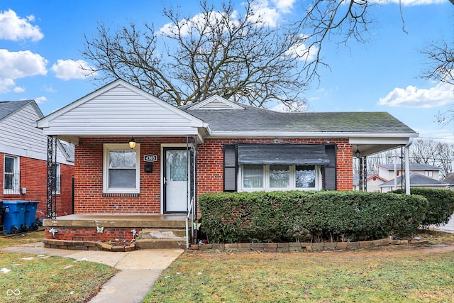 bungalow-style home featuring a front yard and covered porch