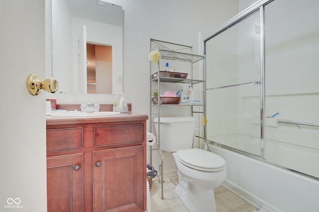 full bathroom with enclosed tub / shower combo, vanity, and toilet