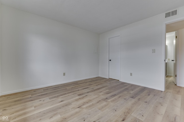 spare room featuring light hardwood / wood-style floors