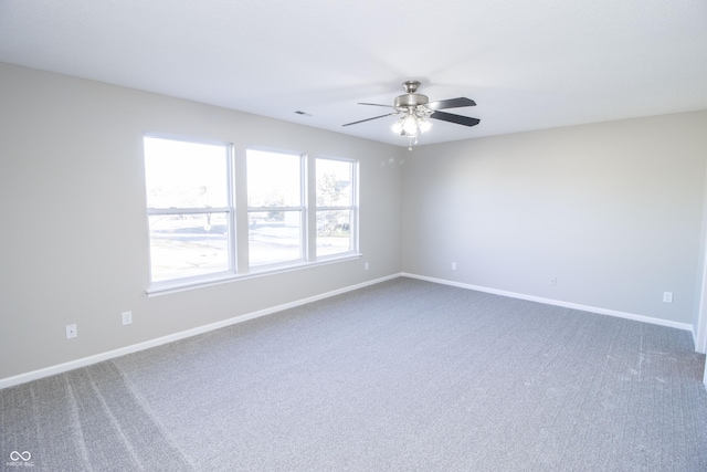 carpeted empty room featuring ceiling fan