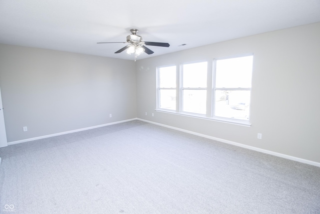 carpeted empty room featuring ceiling fan