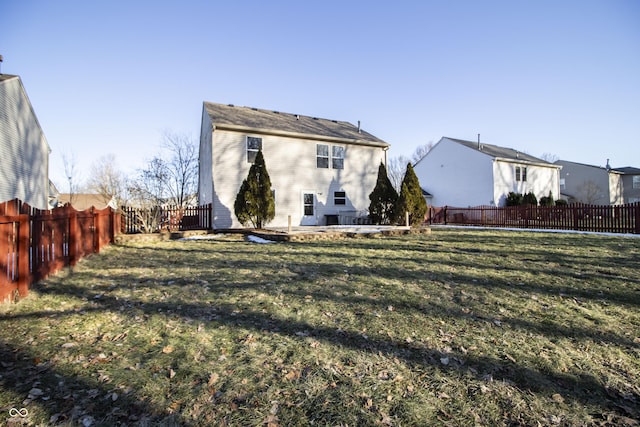 rear view of property featuring a lawn