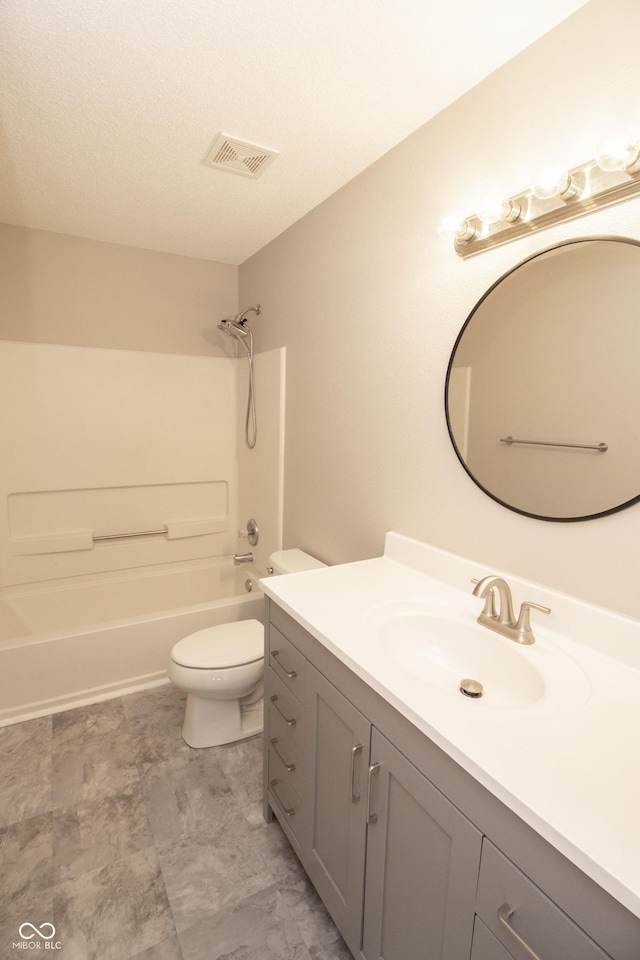 full bathroom featuring vanity, toilet,  shower combination, and a textured ceiling