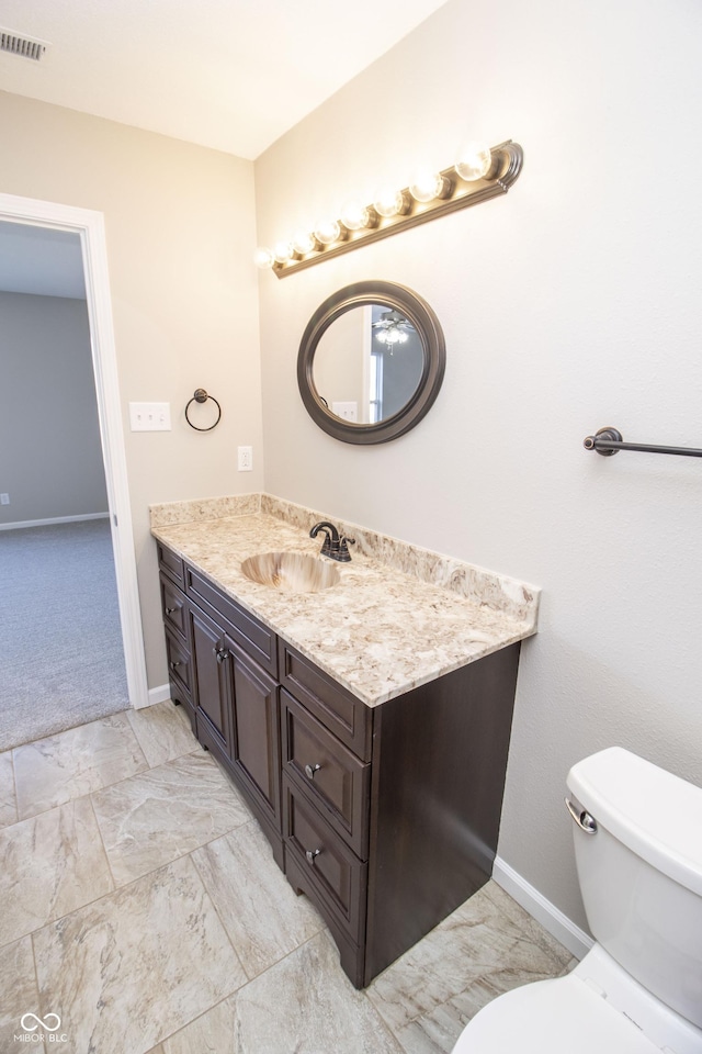 bathroom with vanity and toilet