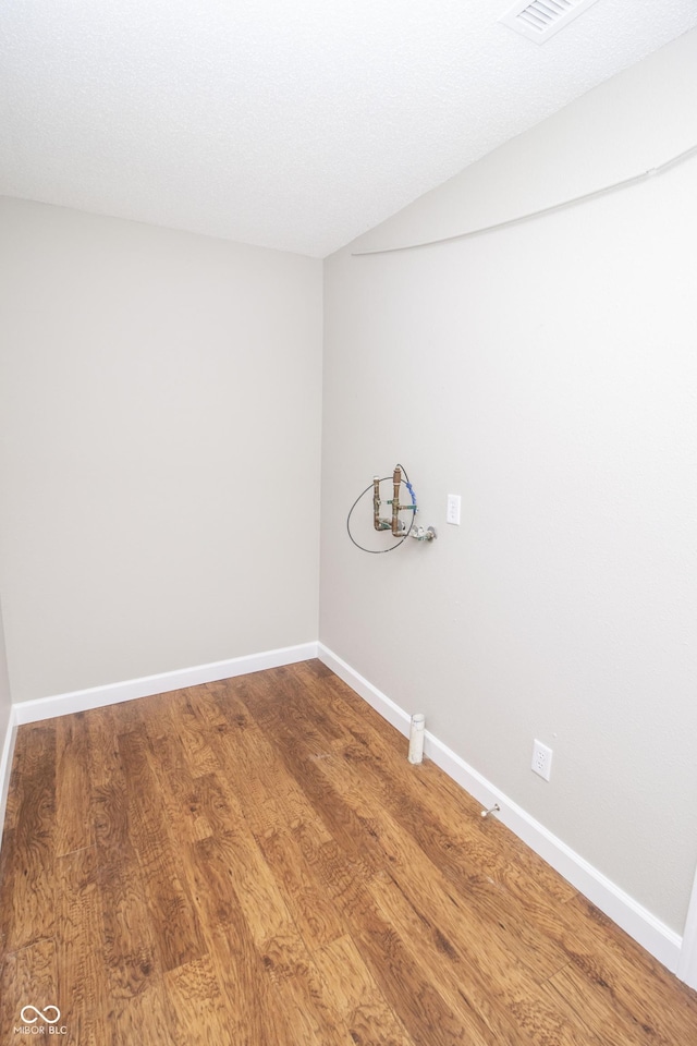 interior space with lofted ceiling and hardwood / wood-style flooring