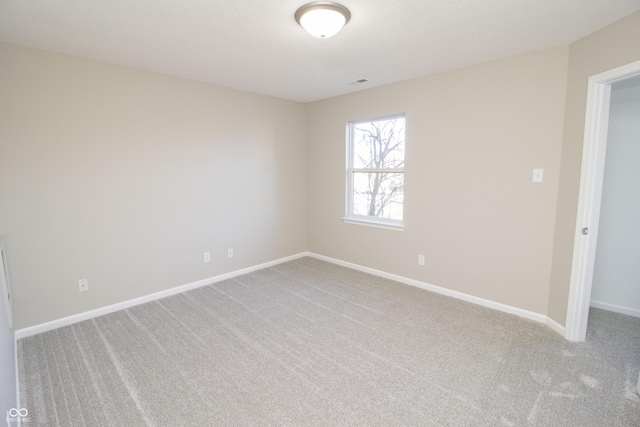 unfurnished room with light carpet