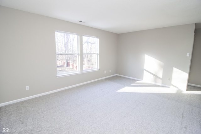 unfurnished room featuring light carpet