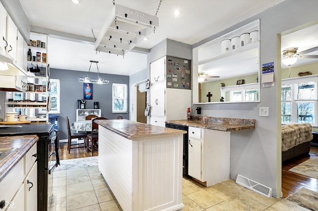 kitchen featuring pendant lighting, ceiling fan, a center island, black dishwasher, and white cabinets