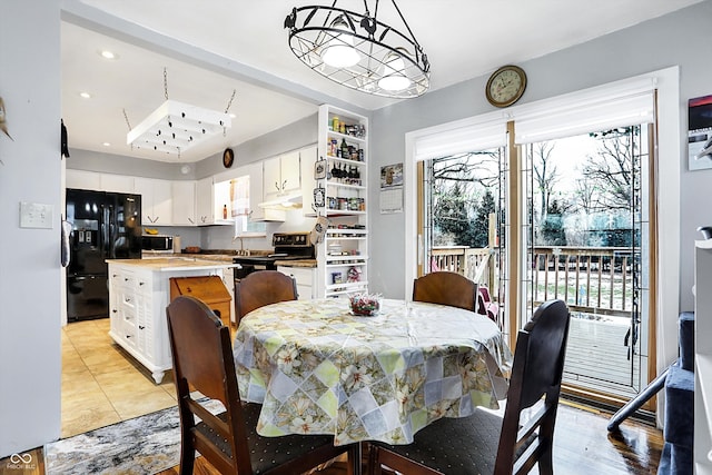 tiled dining room featuring sink