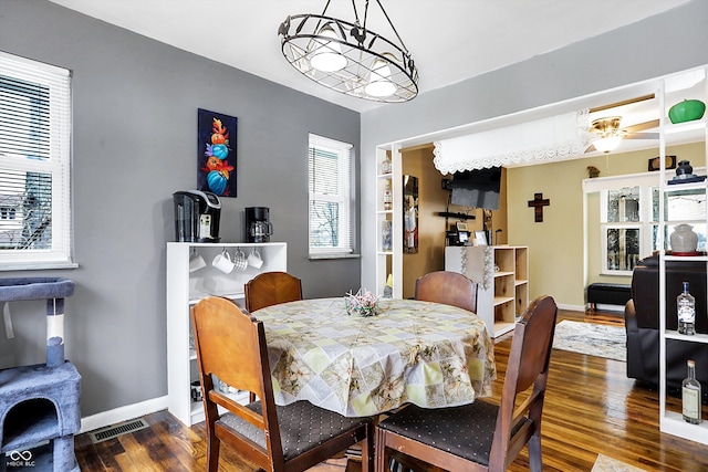 dining space with dark hardwood / wood-style flooring