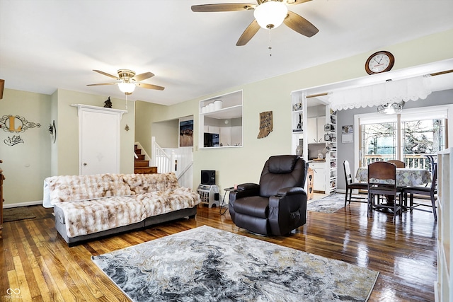 living room featuring ceiling fan and hardwood / wood-style floors