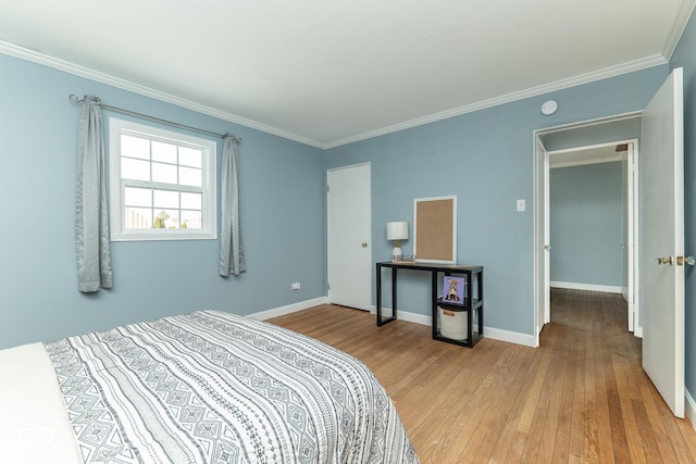 bedroom with crown molding and light hardwood / wood-style floors