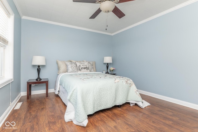 bedroom with multiple windows, crown molding, dark hardwood / wood-style floors, and ceiling fan