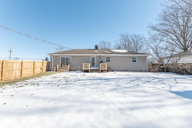 view of snow covered back of property