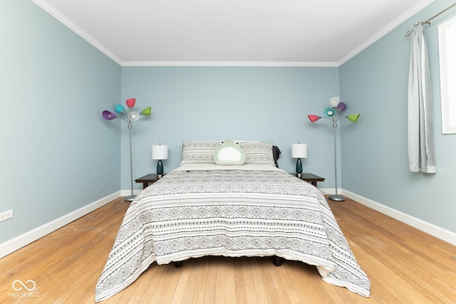 bedroom with hardwood / wood-style flooring and ornamental molding