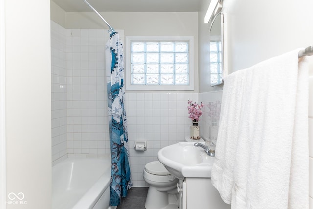 full bathroom with vanity, a wealth of natural light, shower / tub combo with curtain, and tile walls