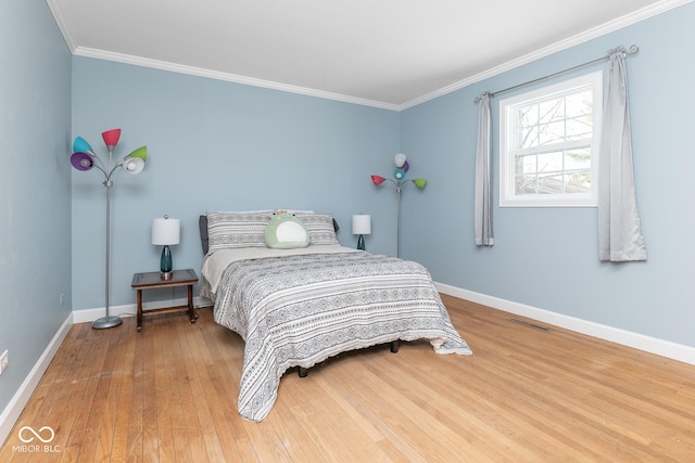 bedroom with hardwood / wood-style flooring and ornamental molding