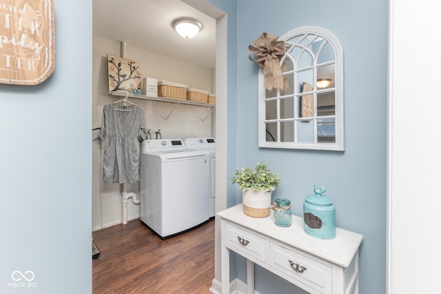 clothes washing area with washer and dryer and dark hardwood / wood-style flooring