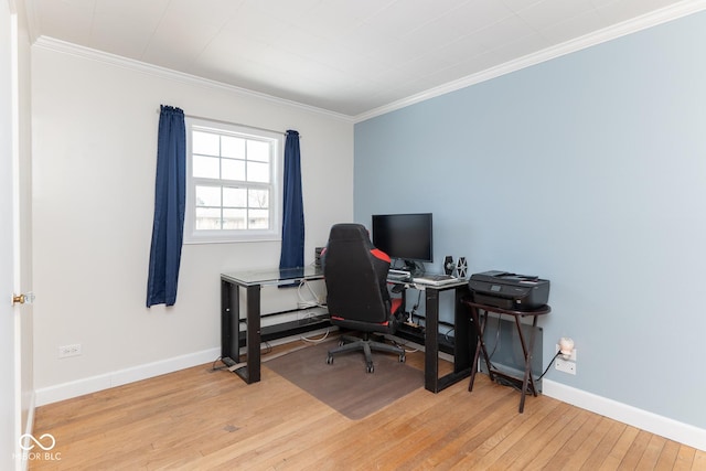 home office featuring ornamental molding and light hardwood / wood-style floors