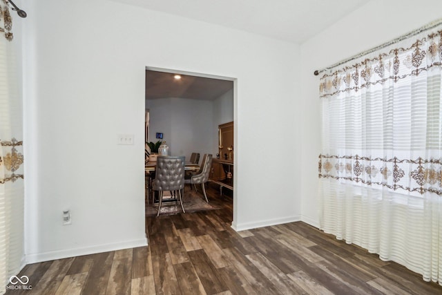 corridor with dark hardwood / wood-style flooring