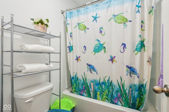 bathroom featuring shower / bath combination with curtain and toilet