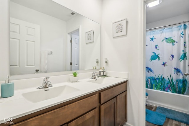 full bathroom with vanity, toilet, and shower / bath combo with shower curtain