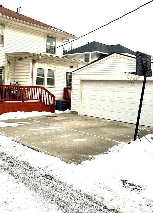 snow covered property featuring central air condition unit