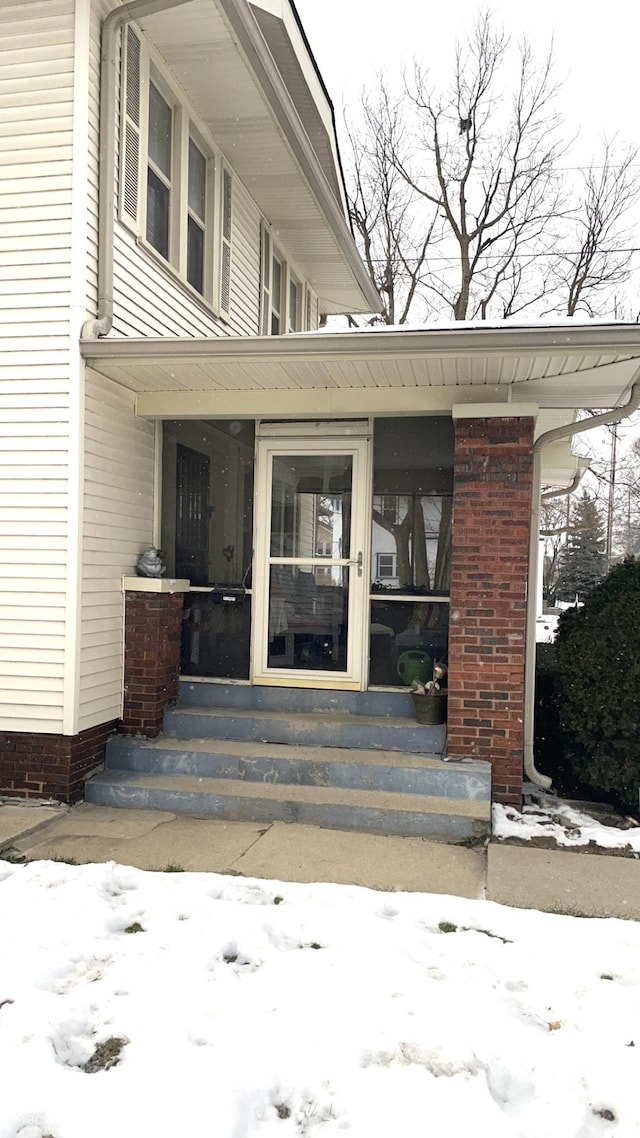 view of snow covered property entrance