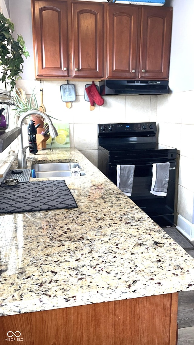 kitchen with black range with electric stovetop, dark hardwood / wood-style flooring, sink, and light stone counters