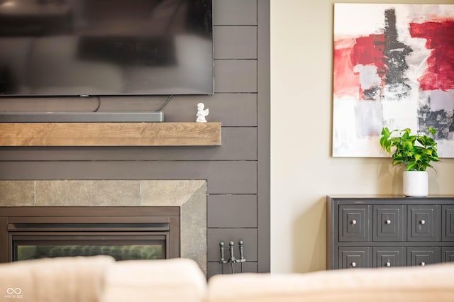 interior details featuring a tile fireplace