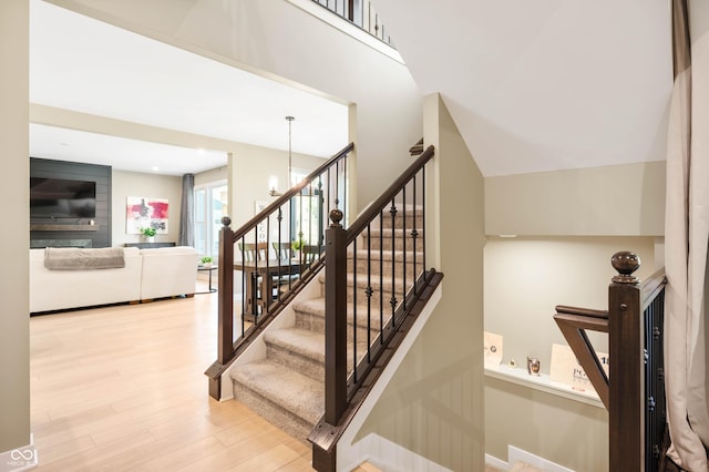 staircase with an inviting chandelier and hardwood / wood-style floors