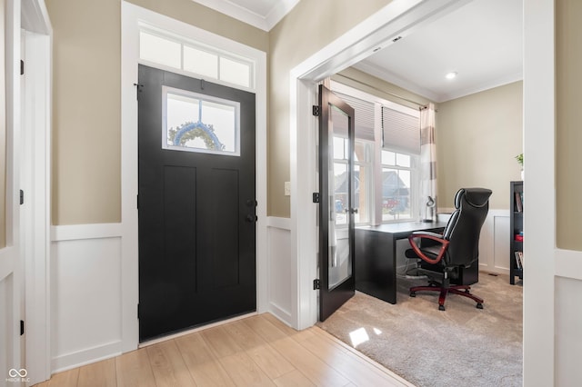 foyer entrance featuring ornamental molding and light hardwood / wood-style floors