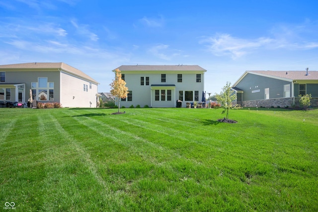 back of house featuring a yard